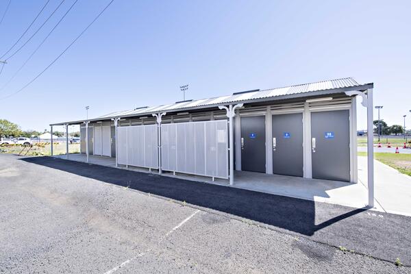 Custom Byron with 16 single cubicles, 4 standard shower cubicles with showers with a service area and allocated handwashing stations with custom design perforated screen